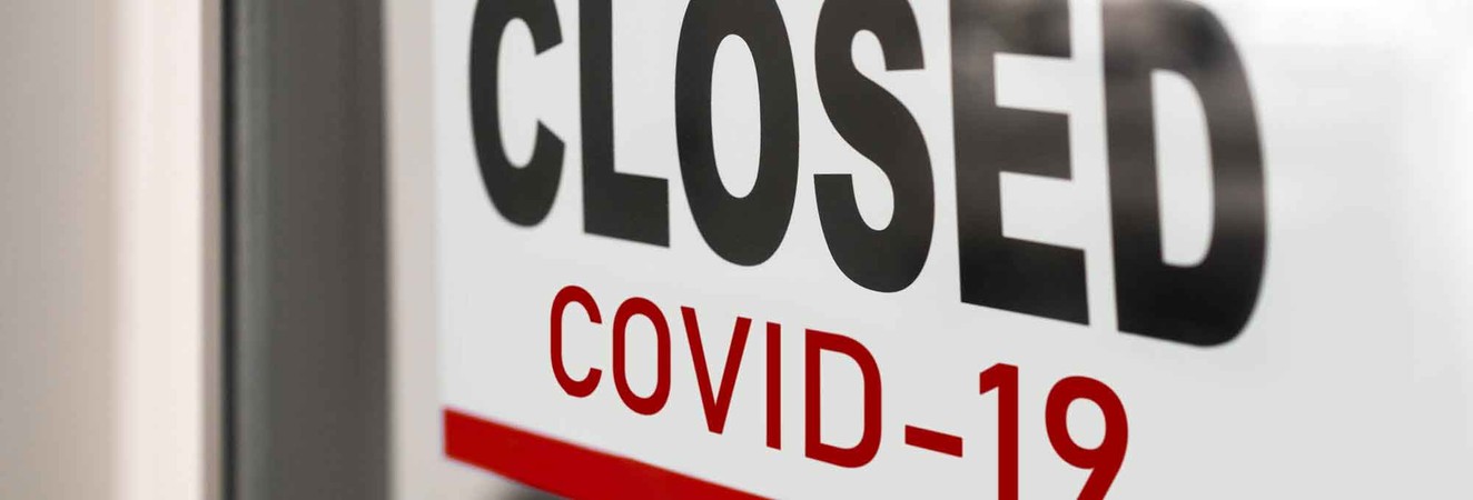 Sign on door reads "Closed COVID-19"