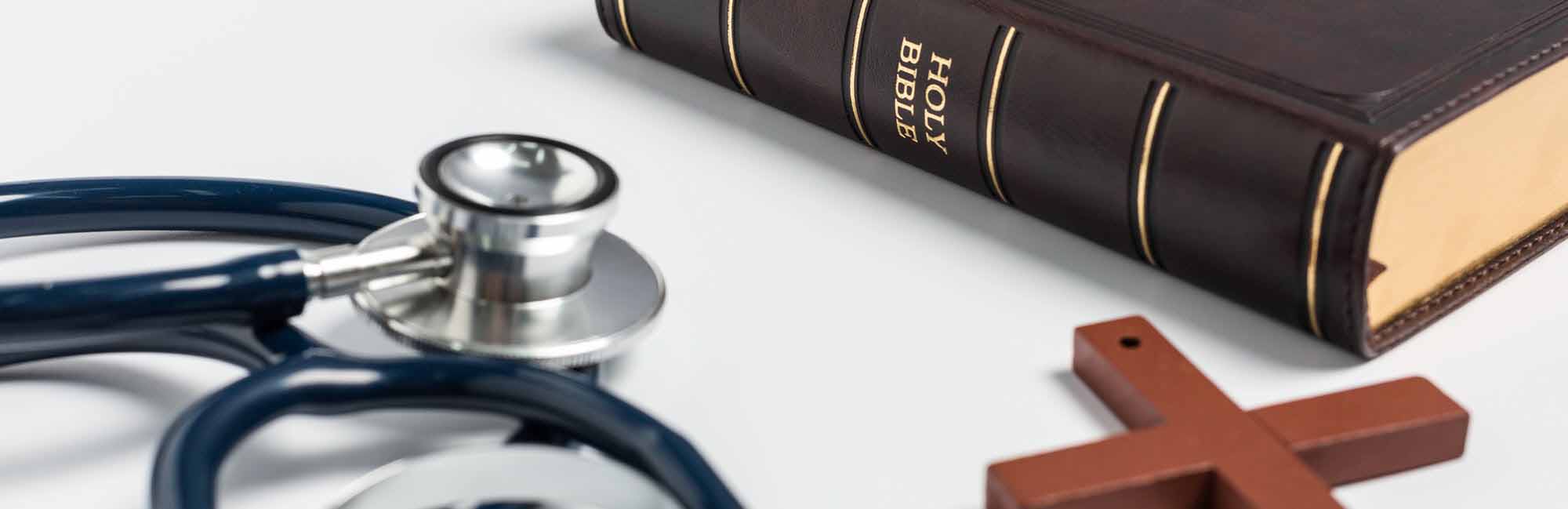 Bible, cross and stethoscope