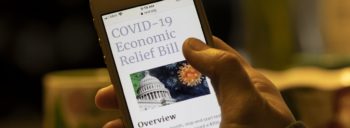 Article about COVID Relief Bill viewed on a smart phone