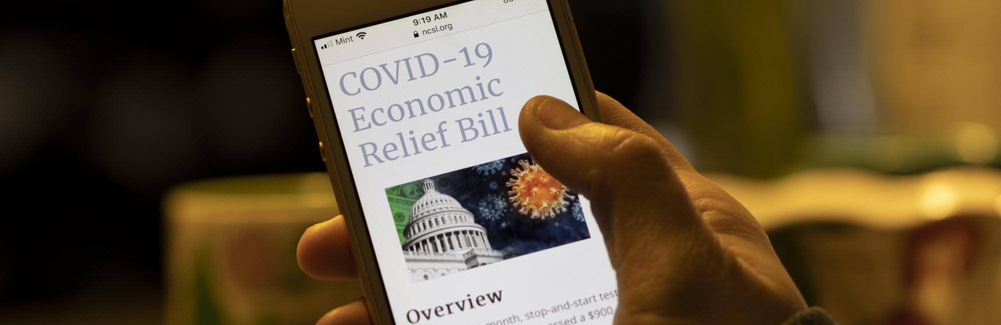 Article about COVID Relief Bill viewed on a smart phone